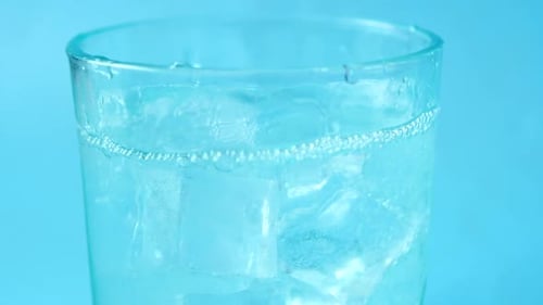 Ice Cubes Dropped Into Refreshing Water