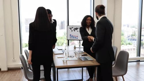 Business Team Meeting with Handshake in Modern Office