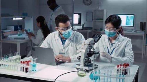 Lab Technicians Conduct Medical Research in Bright Lab