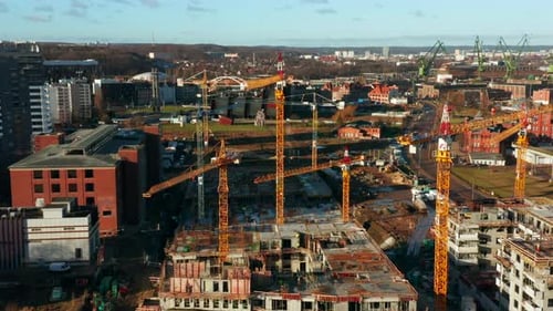 Building Construction with Tower Cranes at Sunset Aerial View