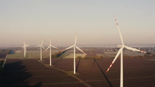 Aerial View of a Wind Turbine Farm During Sunset or Sunrise