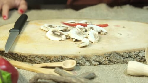 Adding Pepper to Mushrooms on a Cutting Board