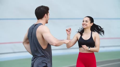 Couple Training Together on Running Track. Woman Runner Exercising on Sport Stadium