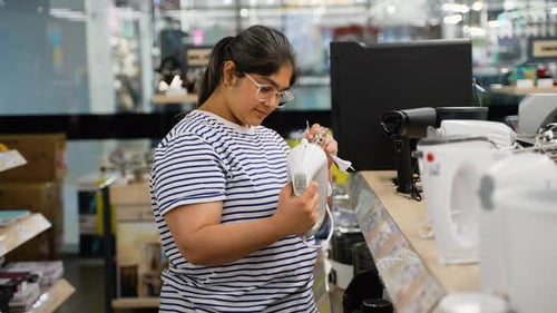 Indian Woman Chooses a Mixer Blender in the Appliances Store