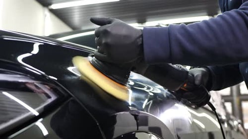 Professional Detailing a Car in Car Studio Hands with Orbital Polisher Scratching Remover