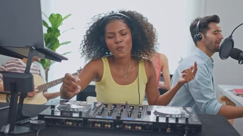 Group of diverse stylish audio producer working in music record studio