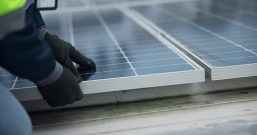 Hands, technician and solar panel on inspection in rooftop in city building for green energy