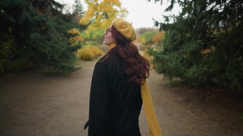 Serene Autumn Walk Lady Adjusts Hair in Yellow Beret and Scarf