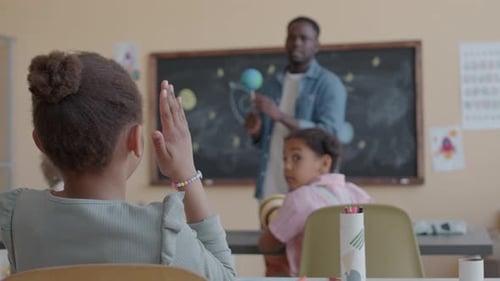 Girl Asking Question on Astronomy Lesson in Elementary School