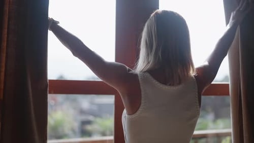 Enjoy Early Morning Woman Opening Curtains in Bedroom Back View Traveling Female Tourist Admiring
