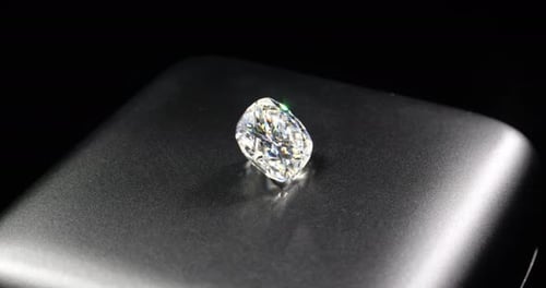 Shimmering Square-Cut Diamond on a Shiny Surface