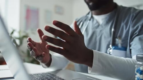 Medical Professional Consults via Telehealth Showing Pills