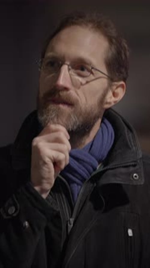 Man with Beard and Glasses Thinking Indoors