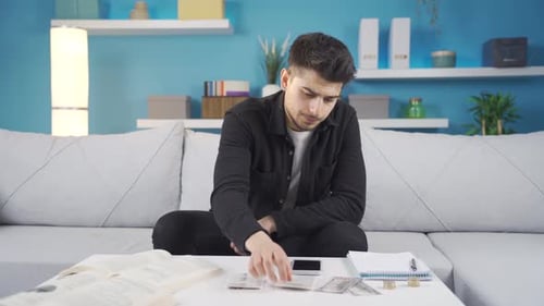 Young student man experiencing financial difficulties is unhappy.