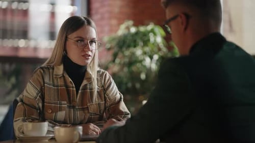 Business Partners Sitting Together in Cafe Talking at Coffee Break