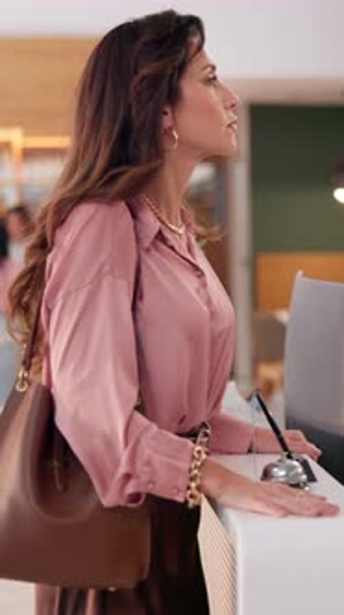 Woman, customer and angry with bell at hotel reception for poor service, hospitality and help