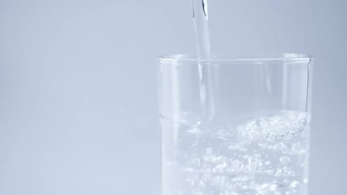 Water Being Poured into Glass in Close Up