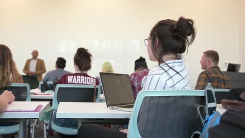 Students Listen to Instructor in Bright Classroom Setting