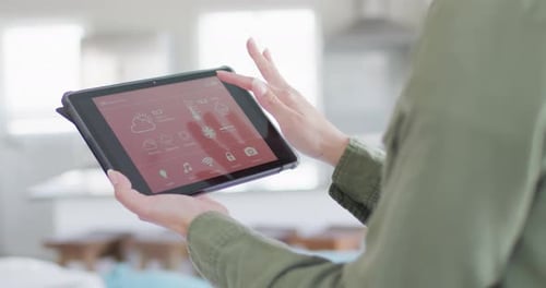 Woman Using Smart Home App on Tablet Device
