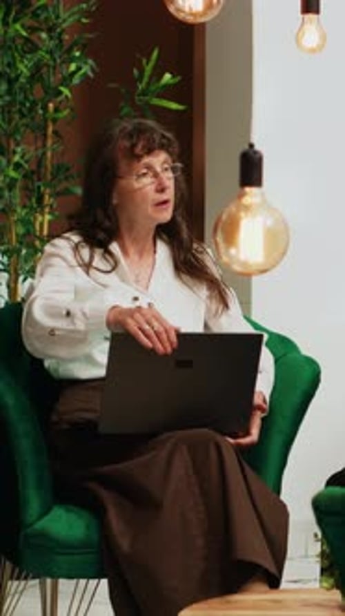 Vertical Video People Passing Time in Hotel Lobby