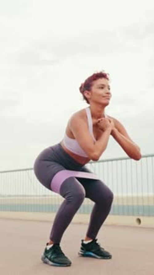 Woman Exercising with Resistance Band in Urban Setting