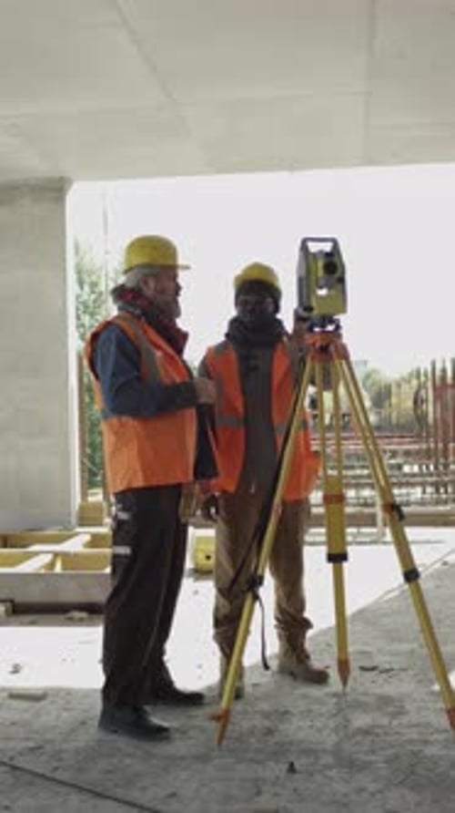 Contractors Using Total Station at Construction Site