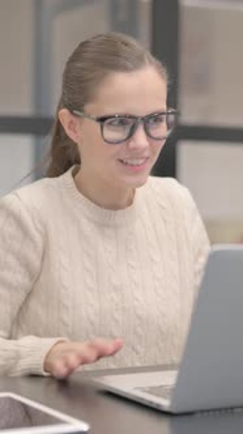 Young Woman Doing Video Chat in Office