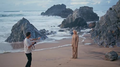 Man Professional Shooting Model on Ocean Beach Shore Girl in Suit Posing Camera