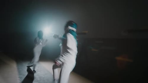 Blurried Fencing Fight on Rapiers Between Foilswomen