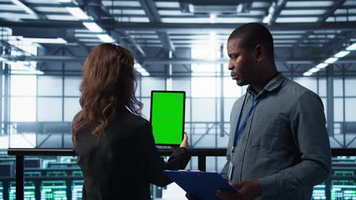 Computer Scientists in Data Center Use Mockup Tablet Inspecting Server Rigs