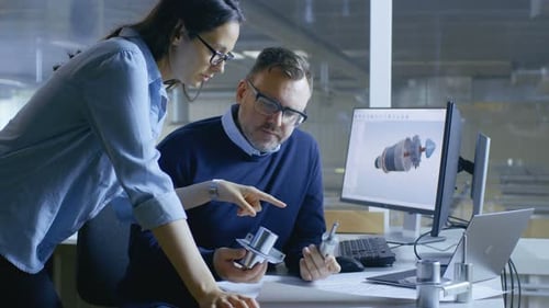 Female Industrial Technician and Male Chief Engineer Designing 3D Turbine/ Engine Model with Help o