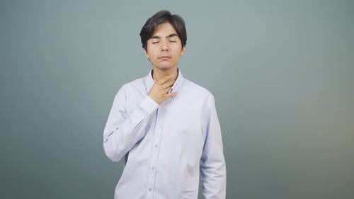 Young Adult Gripping Throat in Pain