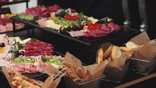Elegant Food Buffet Featuring Meats, Cheeses, and Fruits