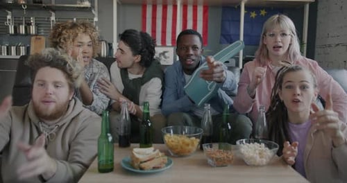 Six Friends Cheer on Their Team Together Indoors