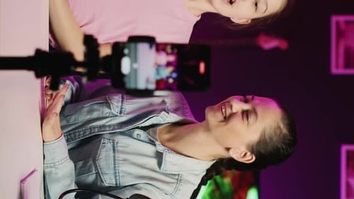 Little Girl and Her Mother Recording Reaction to Internet Clips for Family Channel