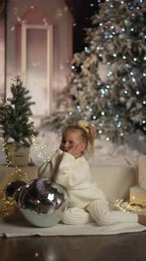 Smiling Child with Christmas Decorations and Disco Ball
