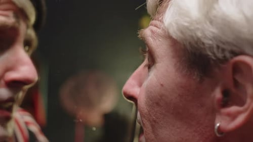 Clown Preparing for Performance Backstage in Dressing Room