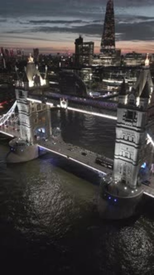 Aerial video of the city of London and the lighthouse bridge in London at night
