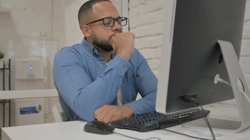 Man Thinking in Front of Computer at Work