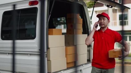 Delivery man, driver calling to customerr for sending parcel box package in the cargo truck at home