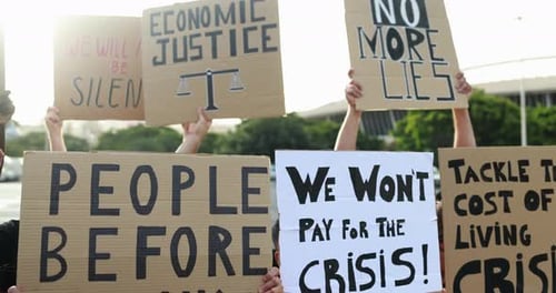 Diverse protesters march against inflation and rising cost of living in the city