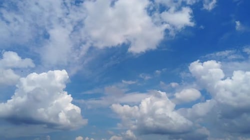 Fluffy Clouds Drifting Across a Blue Sky
