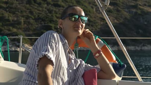 Young, Beautiful Woman Relaxing While Sailing Boat on Sea Admire