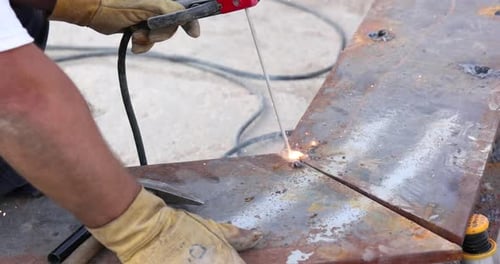 Adult Welding Metal Plates Together