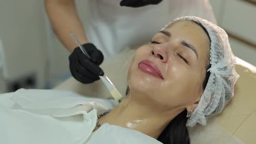 Woman Receiving Facial Treatment in Beauty Clinic