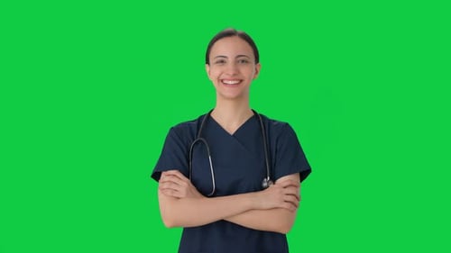 Portrait of Happy Indian female doctor in scrub suit Green screen