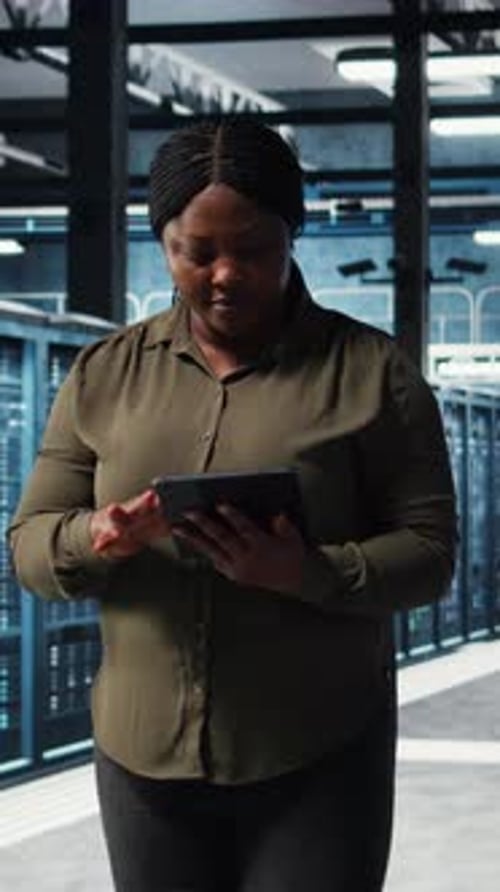 Vertical Video Data Center Engineer Using App on Tablet to Ensure Error Free Rigs
