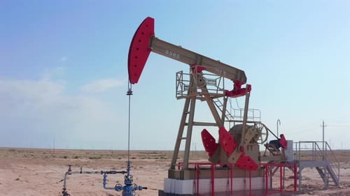 Lonely Oil Pumpjack in Remote Desert Oilfield