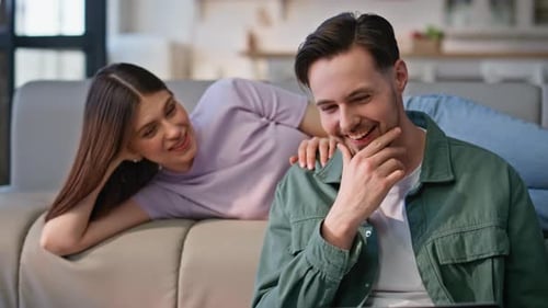 Happy Couple Relaxing at Home with Laptop
