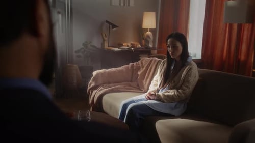 Woman Speaking on Couch in Living Room